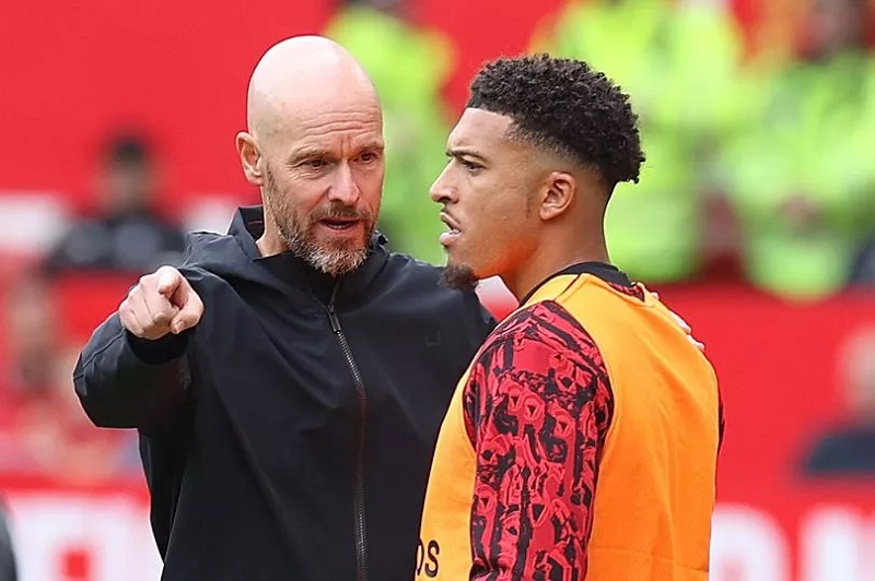 Jadon Sancho hides from the cameras with his hood up in the car as he returns to Manchester United training after falling out with Erik ten Hag over publicly calling him